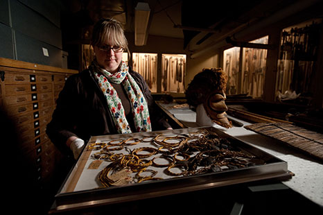 Curator of collections Kathryn Leacock displays a sampling of some of the 6,200 artifacts comprising the P. G. Black Collection.