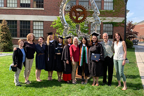 A group photo of faculty and students at commencement.