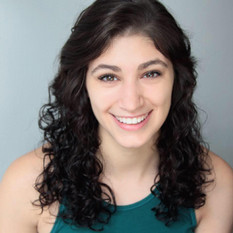 Kayla smiling in a green shirt.