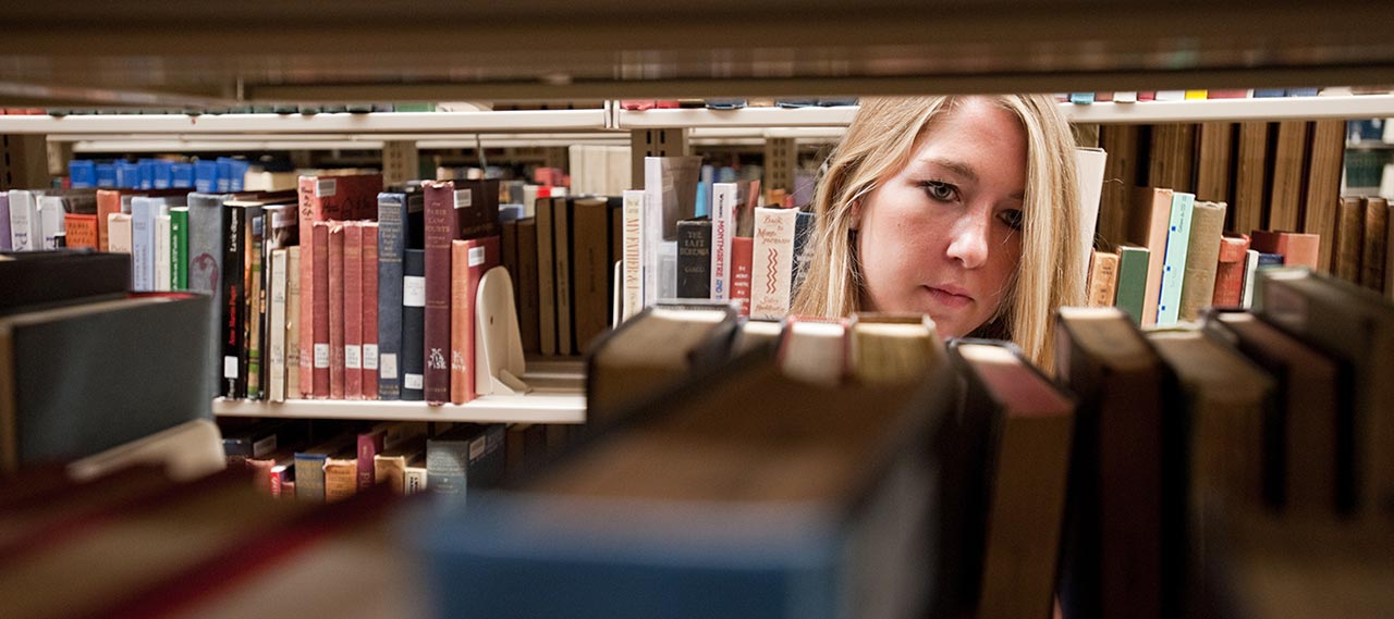 A student in the library stacks.