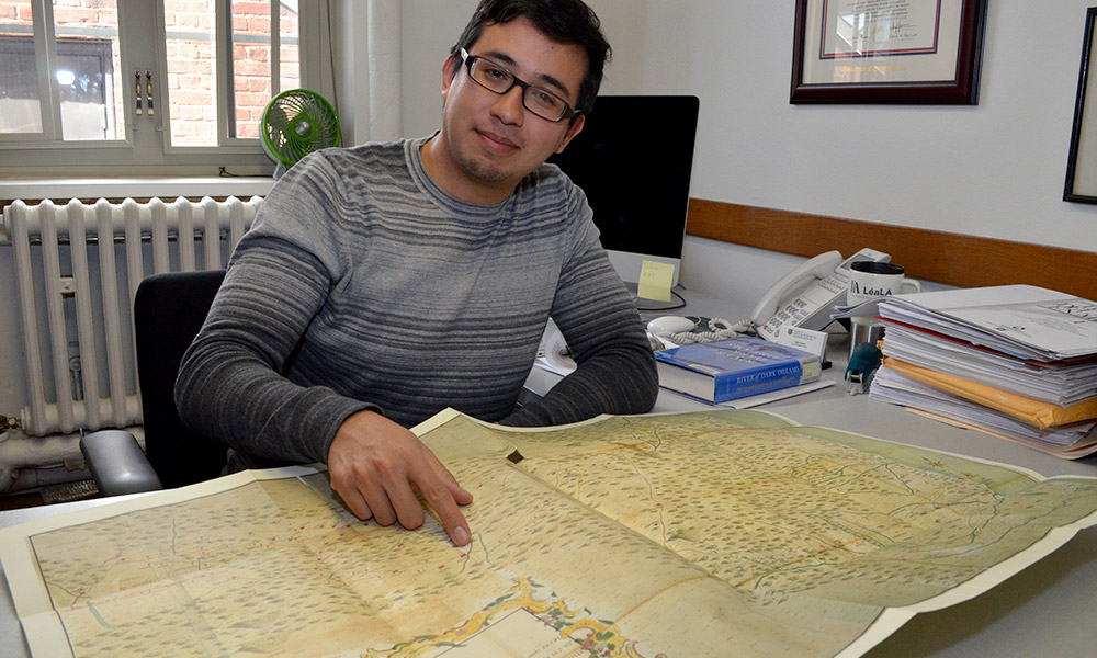 Pablo Sierra, assistant professor of history, points to a route African captives were transported along in colonial Mexico.