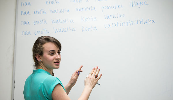 A person standing at a whiteboard in a linguistics seminar.