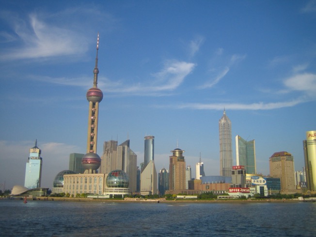 A cityscape in China near water.