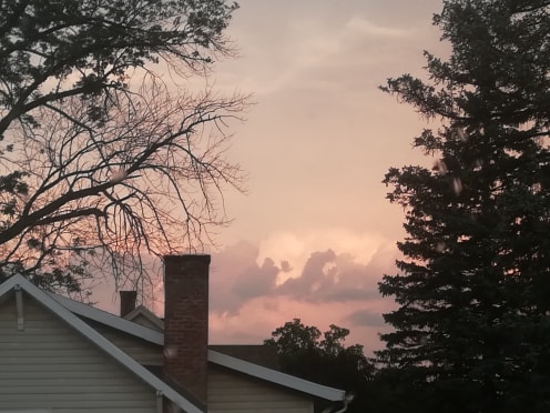 pale sunset over a house roof