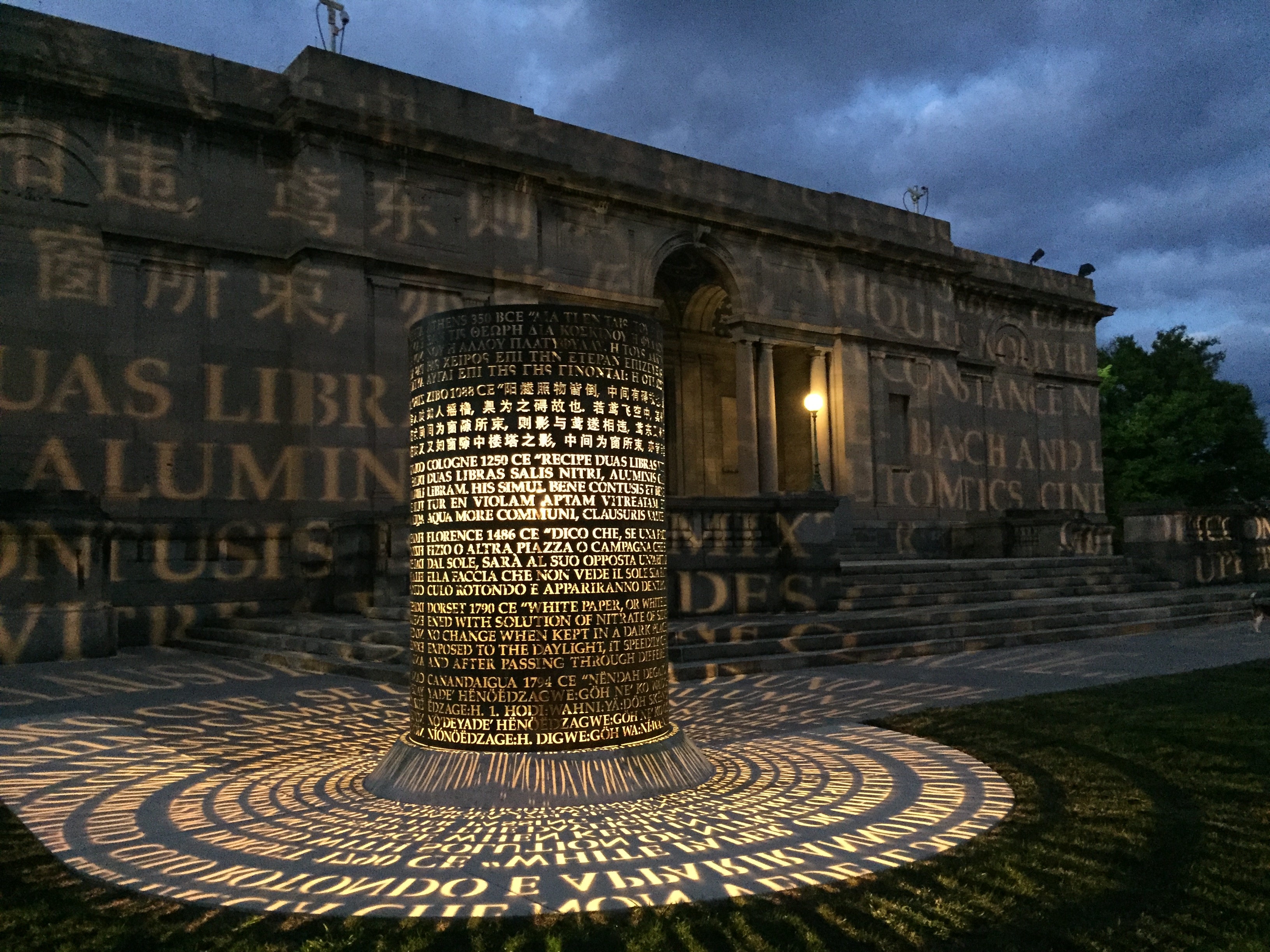 multilingual light-up projected text display outside old building