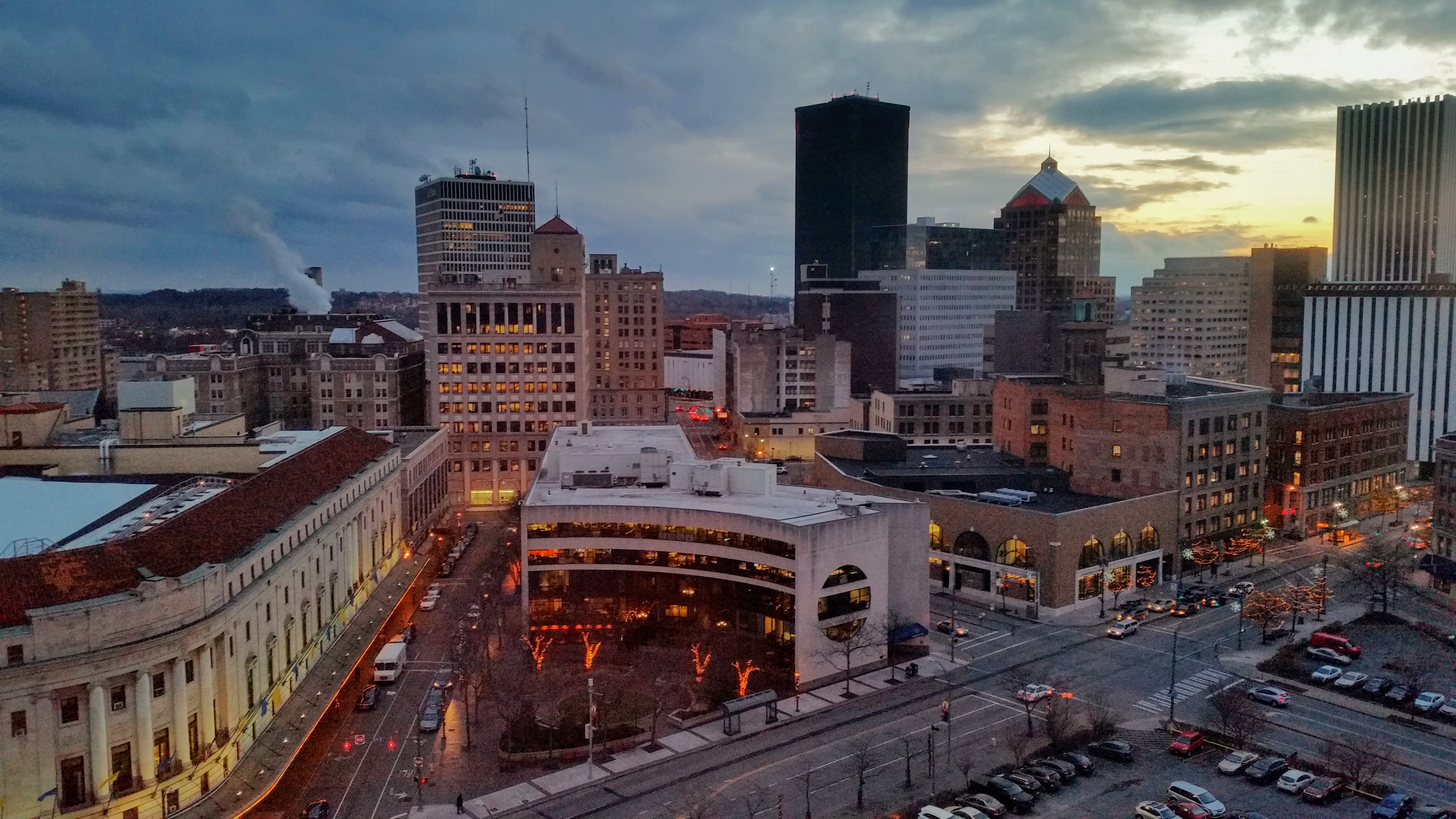 view of eastman theater and surrounding area lit up at sunset