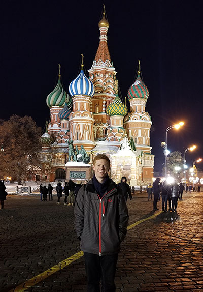 o Robert Parent standing in front of a colorful onion-domed building lit-up at night