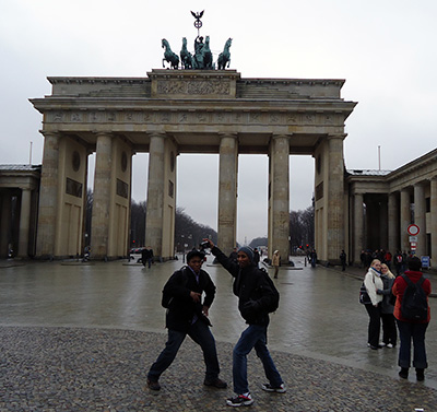 Student having a good time with a friend at the Brandenburg in Berlin, Germany