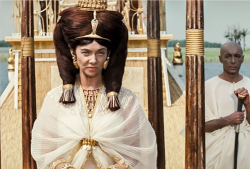 A still image from the movie of a pharaoh on a boat.