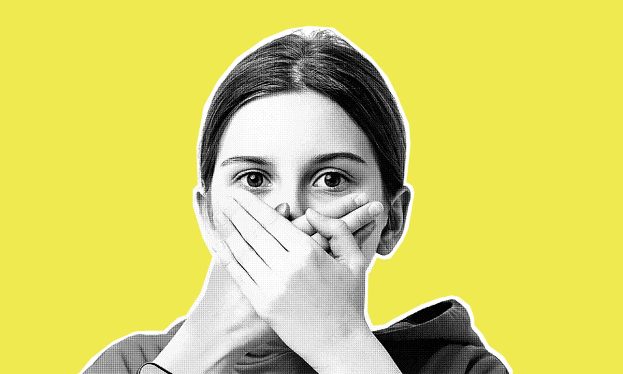 Photo of a young person holding their hands over their mouth like the have a secret they don't want to tell.