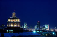 Rush Rhees' distinctive dome and Rochester's skyline at night