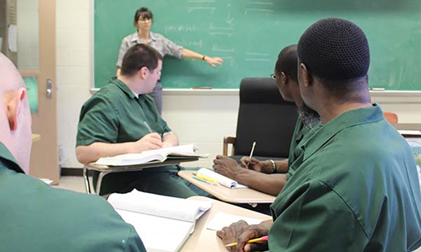 A professor teaching a class for inmates.