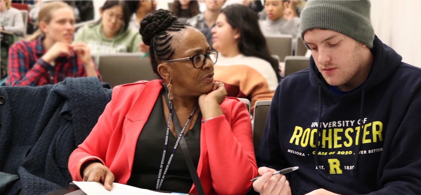 Researcher Precious Bedell and a student engaged in discussion