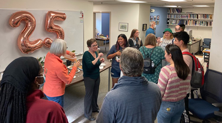 A group of people mingling in an office setting.