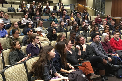 Students in an audience watching storytelling.