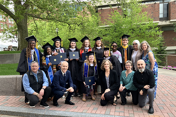 A group photo of faculty and students at commencement.