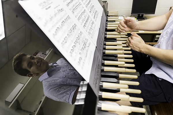 A student playing sheet music on the carillon.