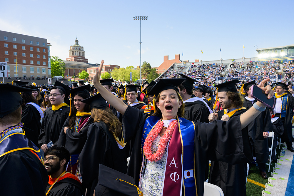 A group of graduates caps and gowns celebrating.