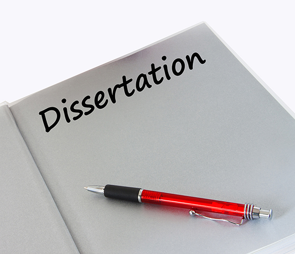 Image of white page in a book with a red pen and the word dissertation.