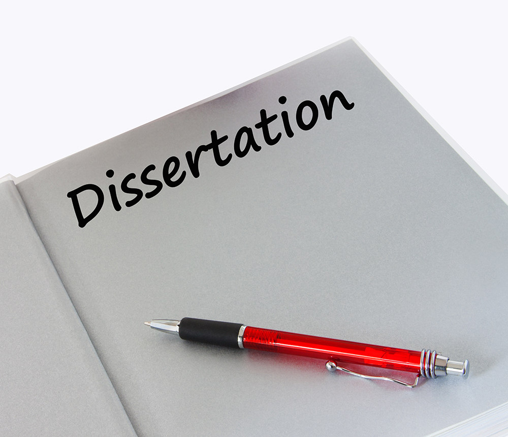 Image of white page in a book with a red pen and the word dissertation.