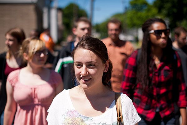 A group of young people walking in an urban area.