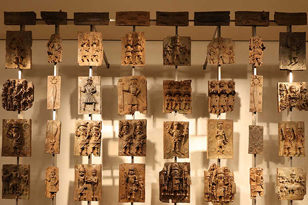 Small relief panels hung on a rack in columns.