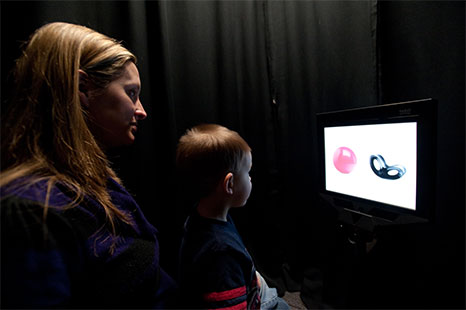 Mother and child looking at images on a screen