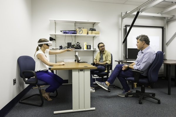 Jose Reynoso works with his NEUROCITY mentor Duje Tadin, PhD, chair of the Brain and Cognitive Sciences Department, and a study subject in his lab in Meliora Hall. // photo by J. Adam Fenster / University of Rochester