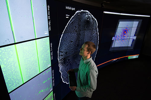 A student looking at results on a large screen in the Vista Collaboratory.