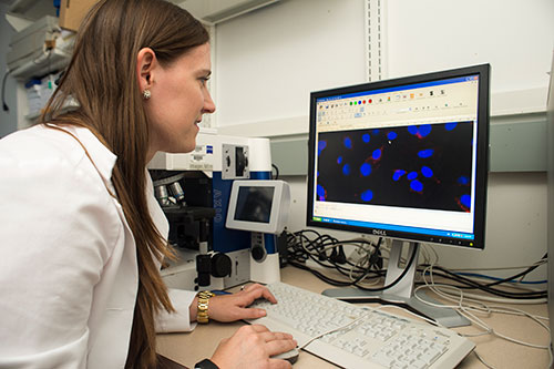 A student looking at results on a computer screen.