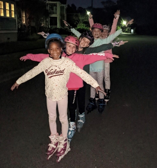 Girls going a dance on rollerblades.