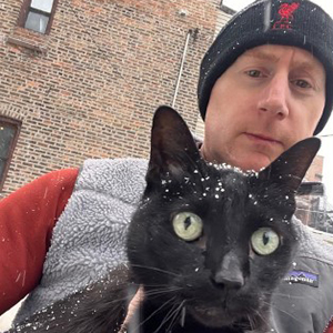 Professor Driver holding a black cat.