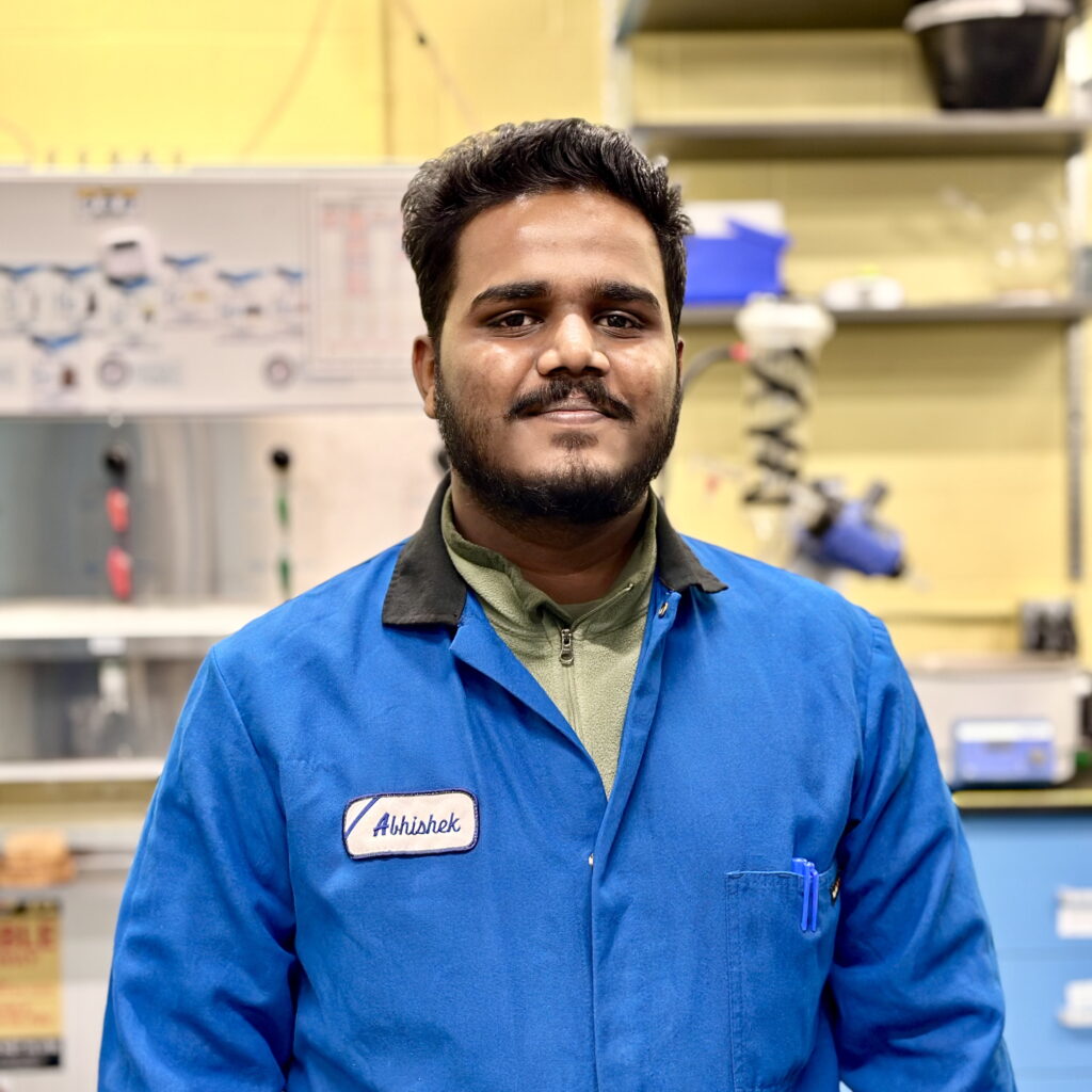 A man in a blue lab coat
