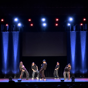 Freeflow dancers on stage with blue lights.