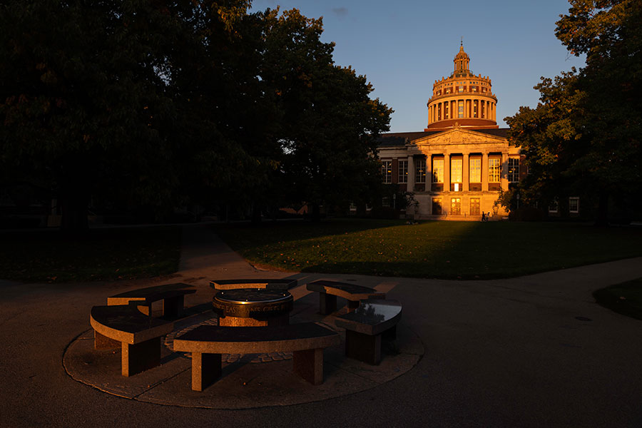 An exterior view of Rush Rhees Library from the Eastman Quad at sunset.