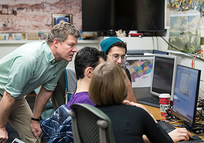 Associate Professor of Atlantic & Early American History Michael J. Jarvis (L) works with students in his digital history course in the DIgital HIstory Lab in Rush Rhees Library.