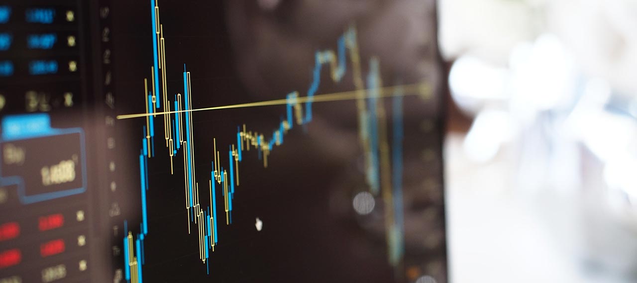 Blue and yellow graph on stock market monitor.