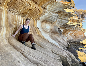 Ren crouched on a rock formation.