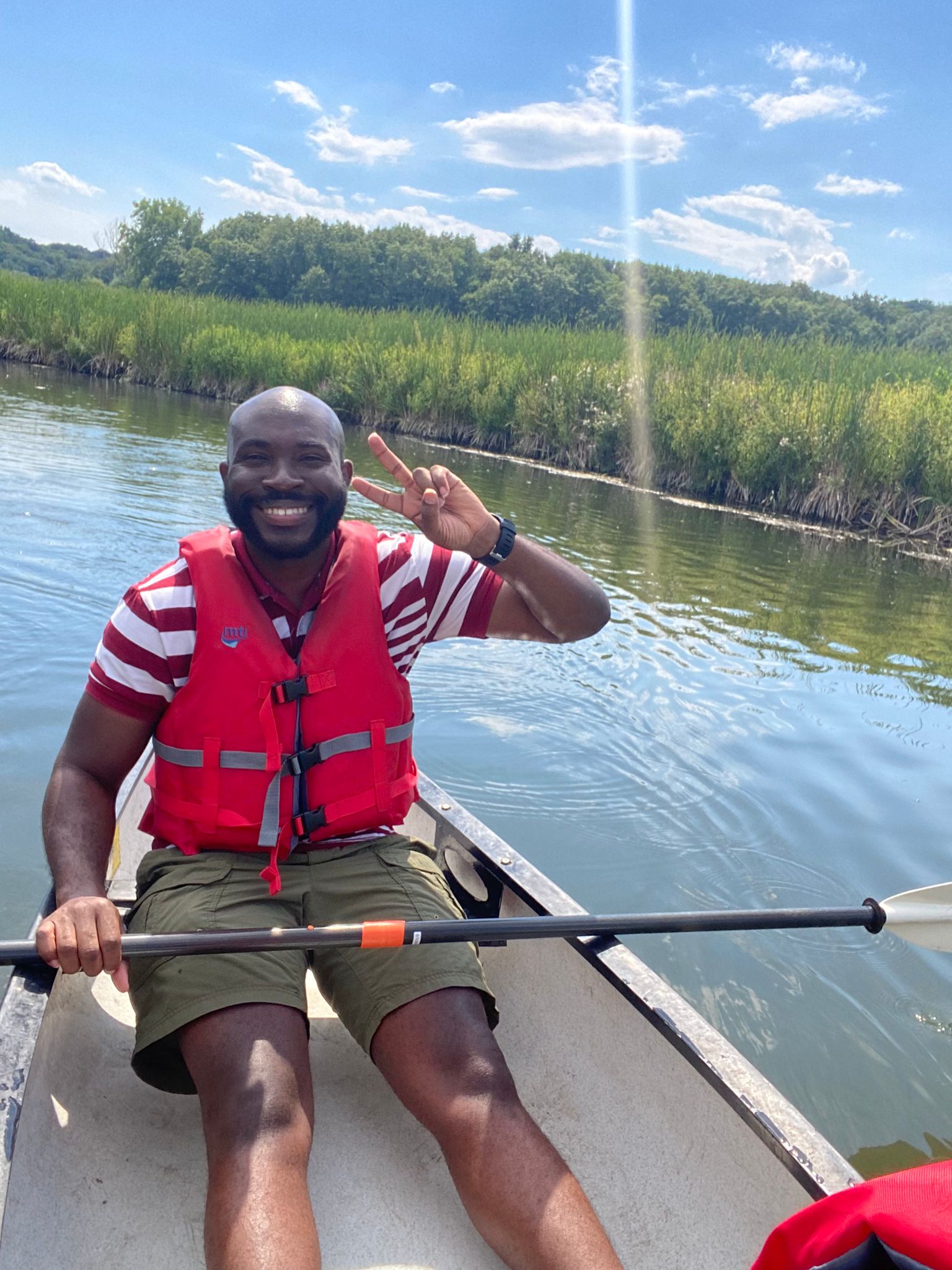 Steve Carr in a canoe on a pond.