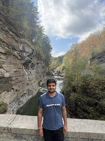 Yadav posing in front of a vast vista.