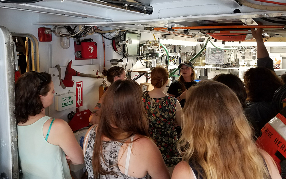 A person speaking to others aborad a ship.