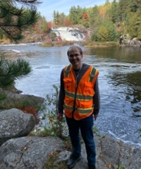 Ian posing next to a river.