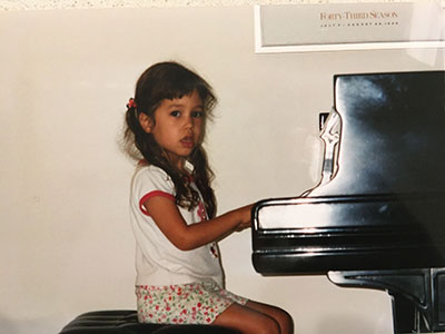 Mitch Klein playing the piano as a child.