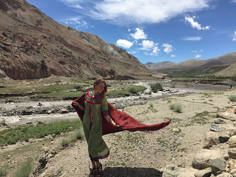 Sophia standing on a trail in an ornate, flowing outfit.