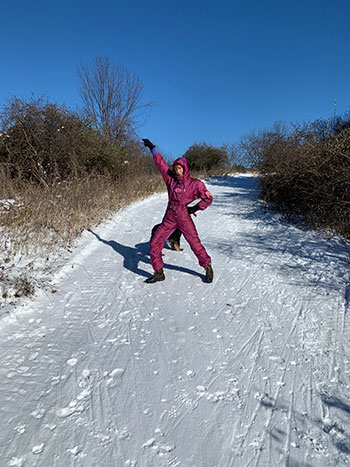 Sophia McRae striking a pose on a snowy trail.