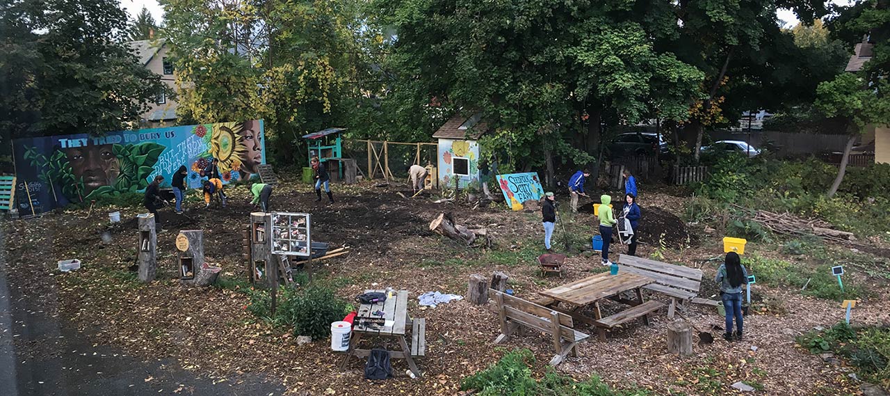 Students working to clean up a community garden