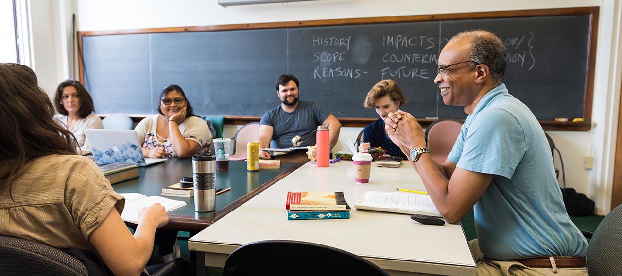 A professor and students in a classroom.