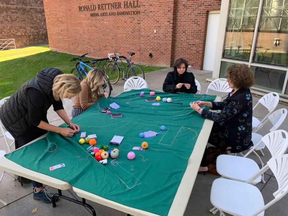 Students embroider banner