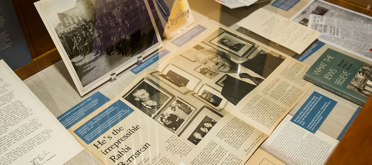 Photos books and newspaper articles on a table.