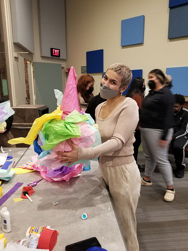 A person shows off their pinata to the camera.